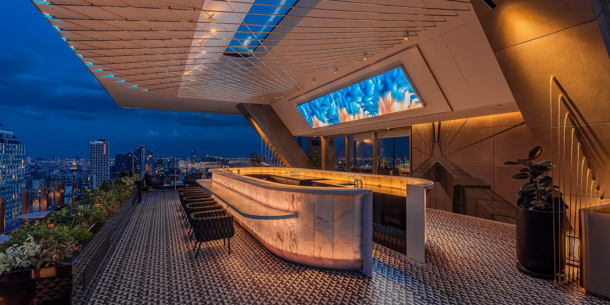 a bar with a large screen on the ceiling