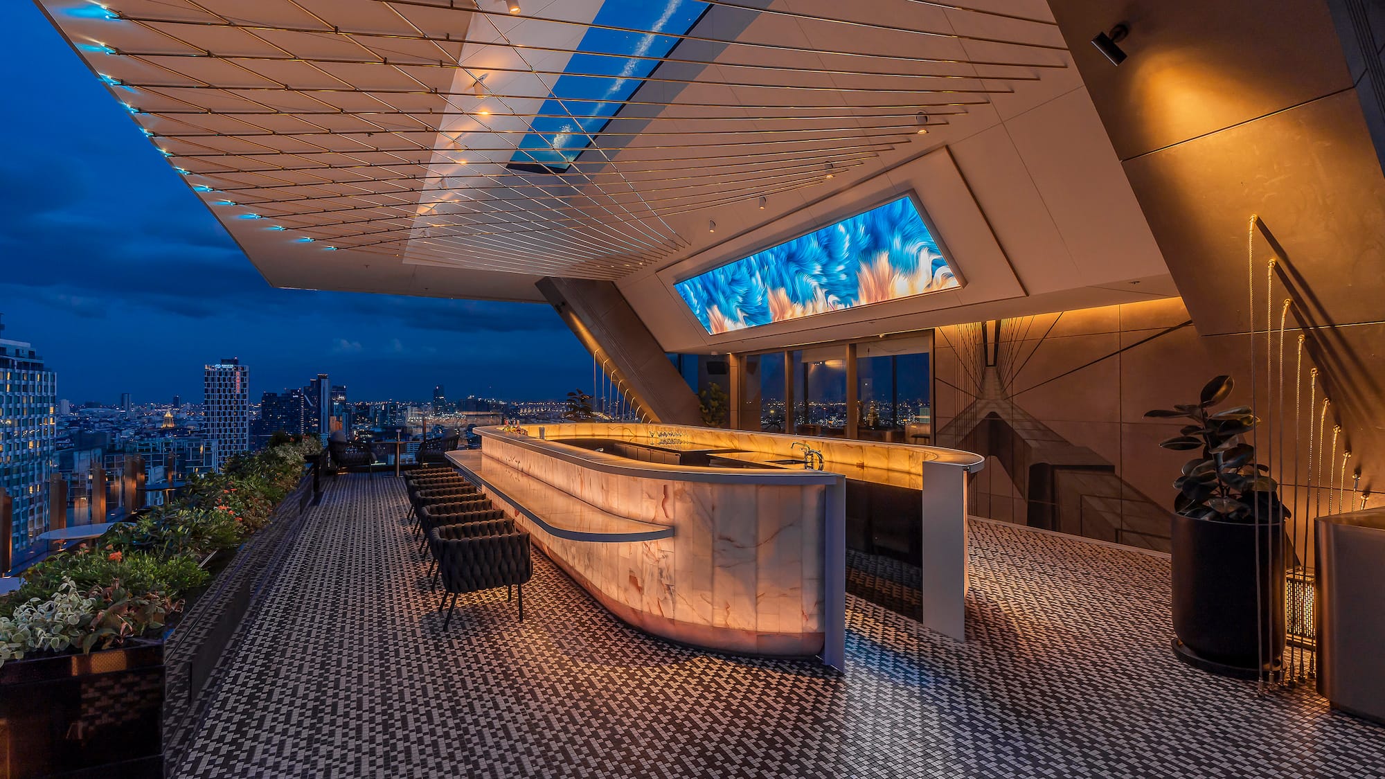 a bar with a large screen on the ceiling