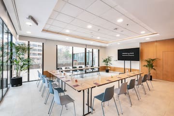 a room with a long table and chairs