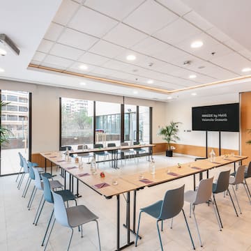 a room with a long table and chairs