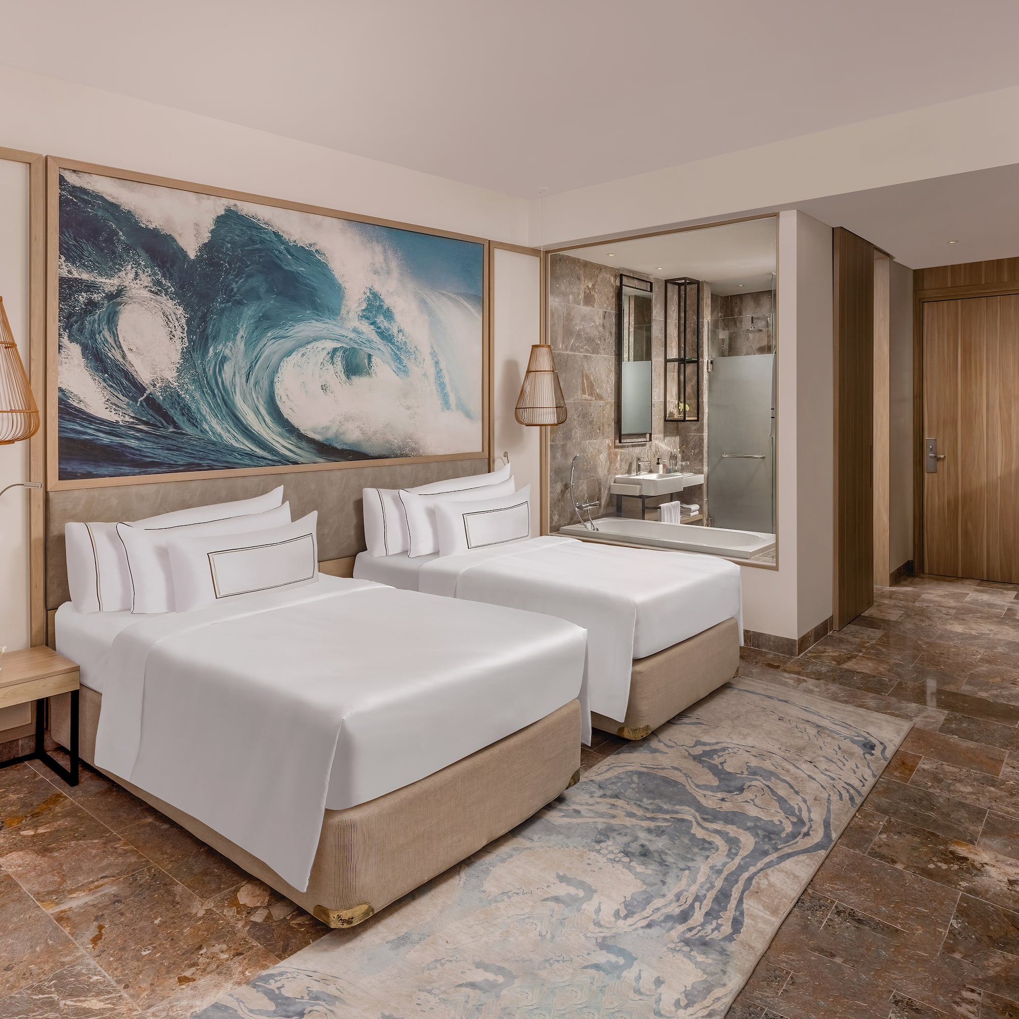 a room with two beds and a mirror