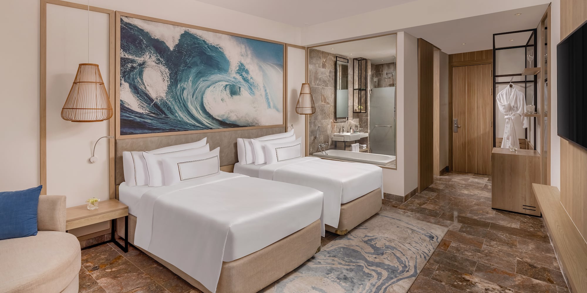 a room with two beds and a mirror