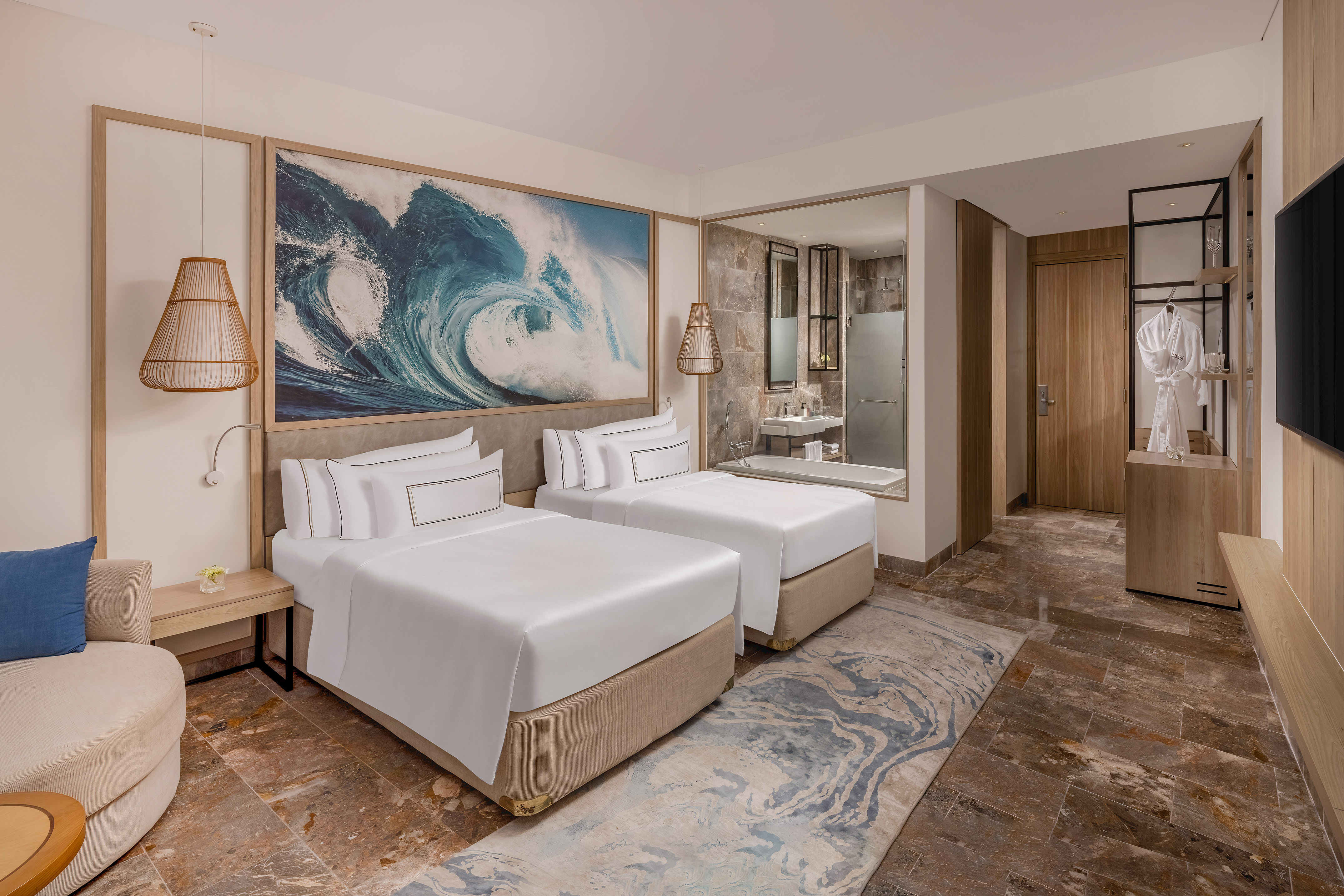 a room with two beds and a mirror