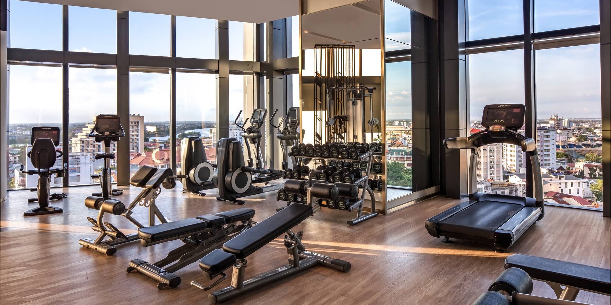 a gym with exercise equipment and a view of the city