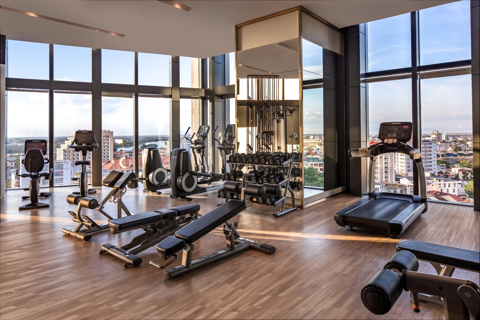 a gym with exercise equipment and a view of the city