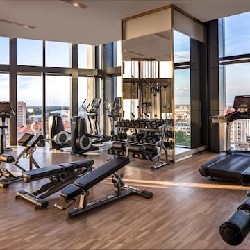a gym with exercise equipment and a view of the city
