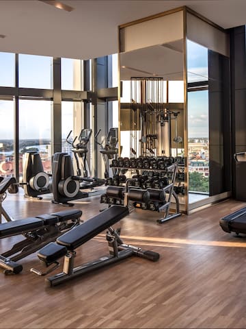 a gym with exercise equipment and a view of the city