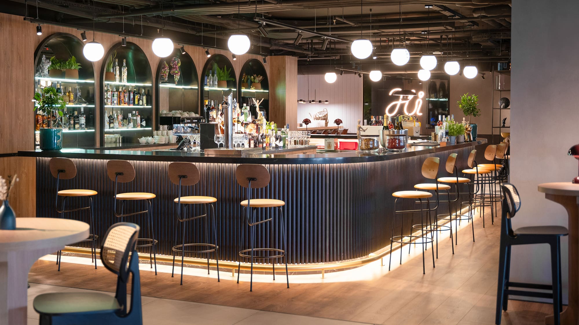 a bar with a row of stools and lights