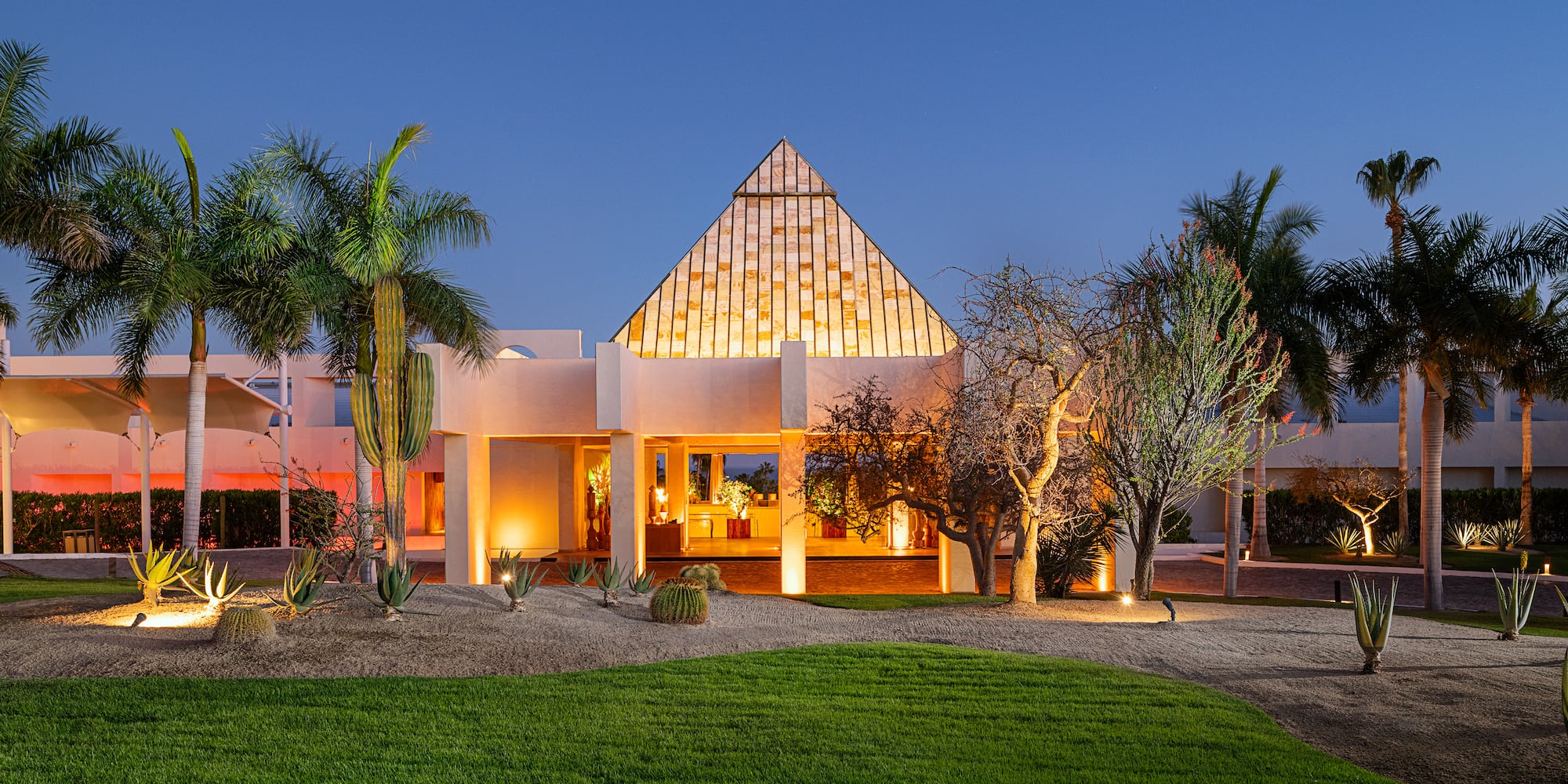 a house with a pyramid shaped roof and a lawn