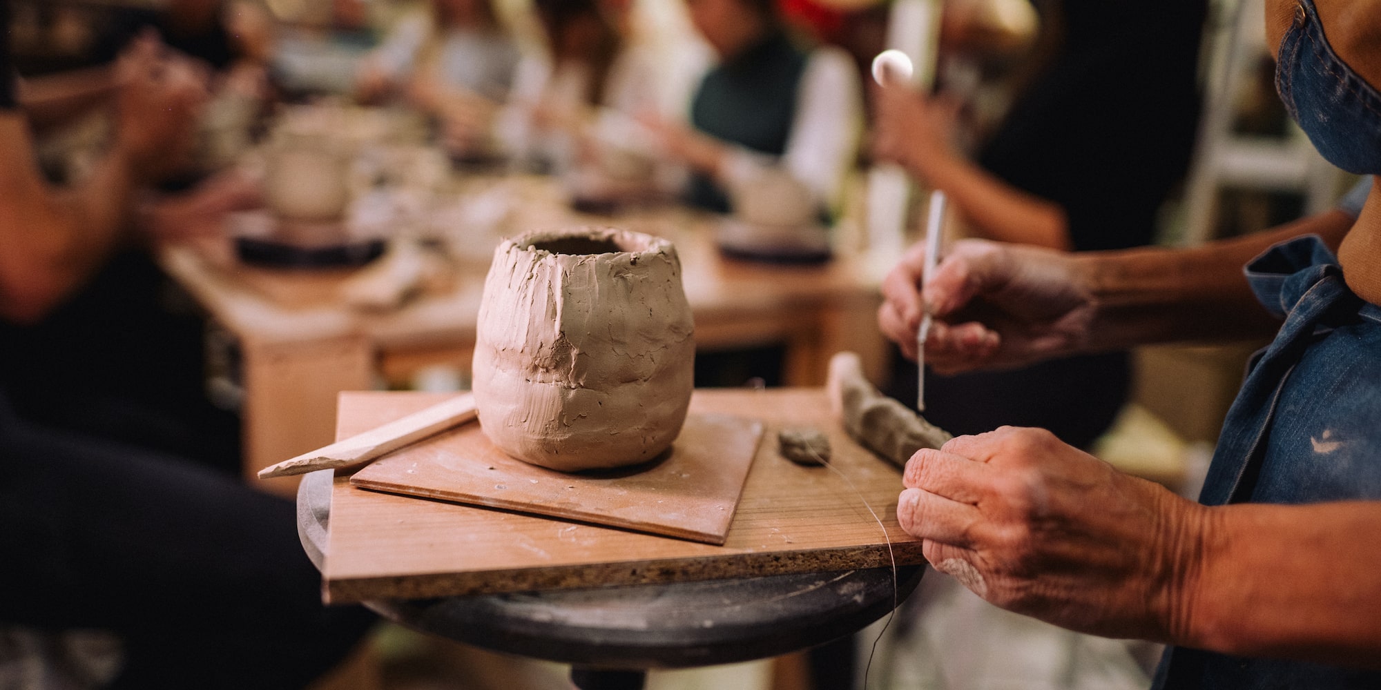 a person working on a clay pot