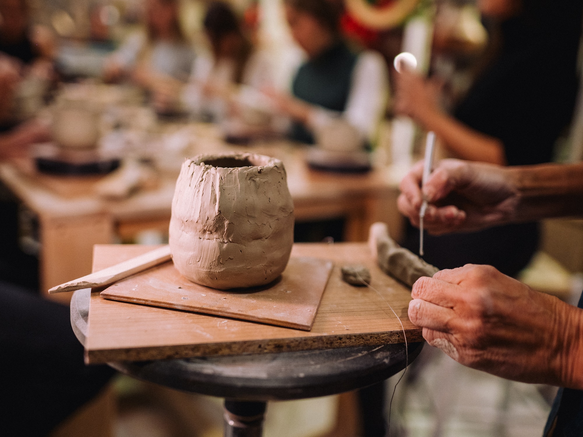 a person working on a clay pot