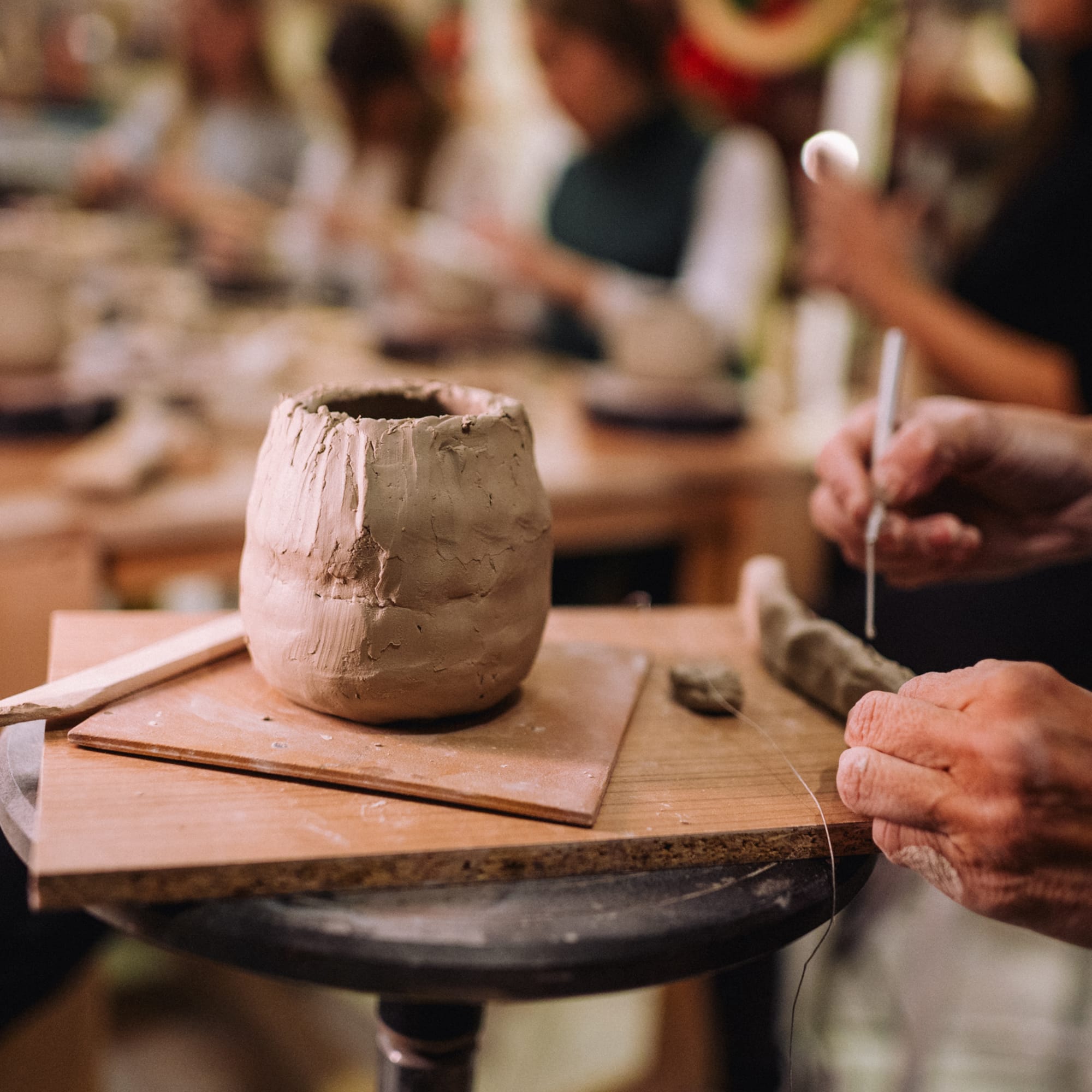 a person working on a clay pot