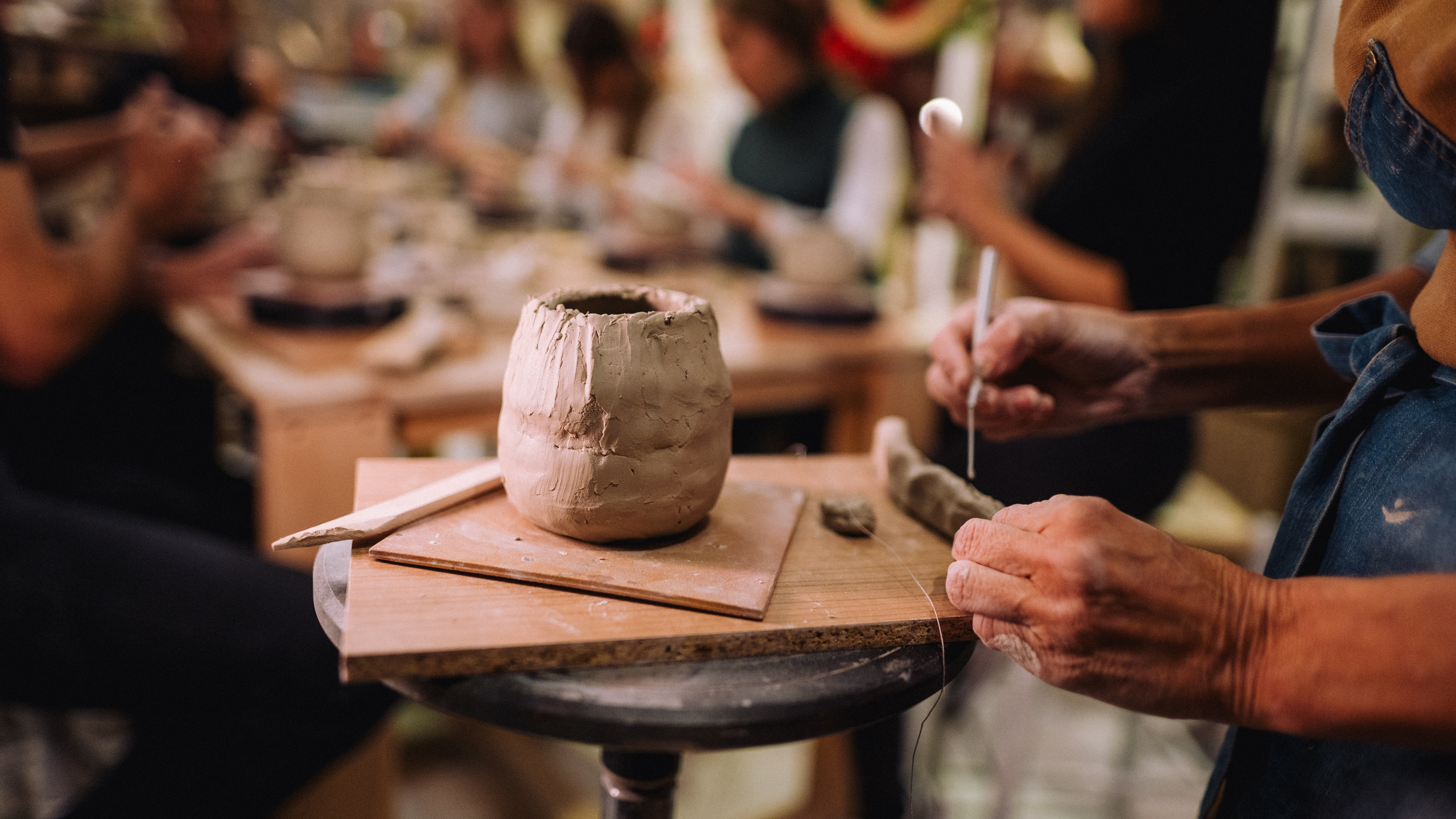 a person working on a clay pot