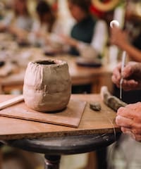 a person working on a clay pot