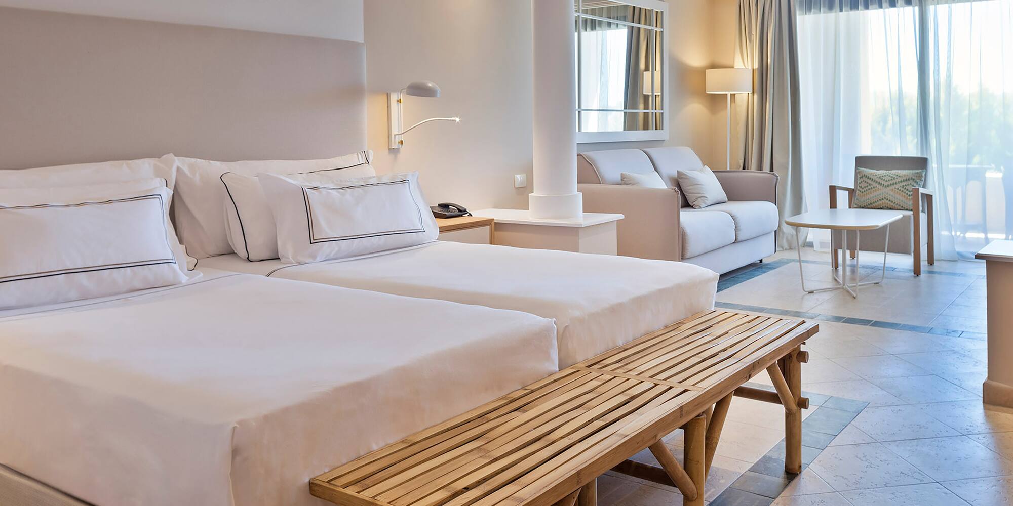 a room with two beds and a table