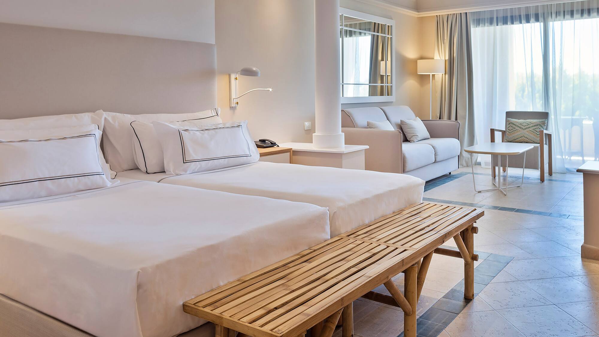 a room with two beds and a table