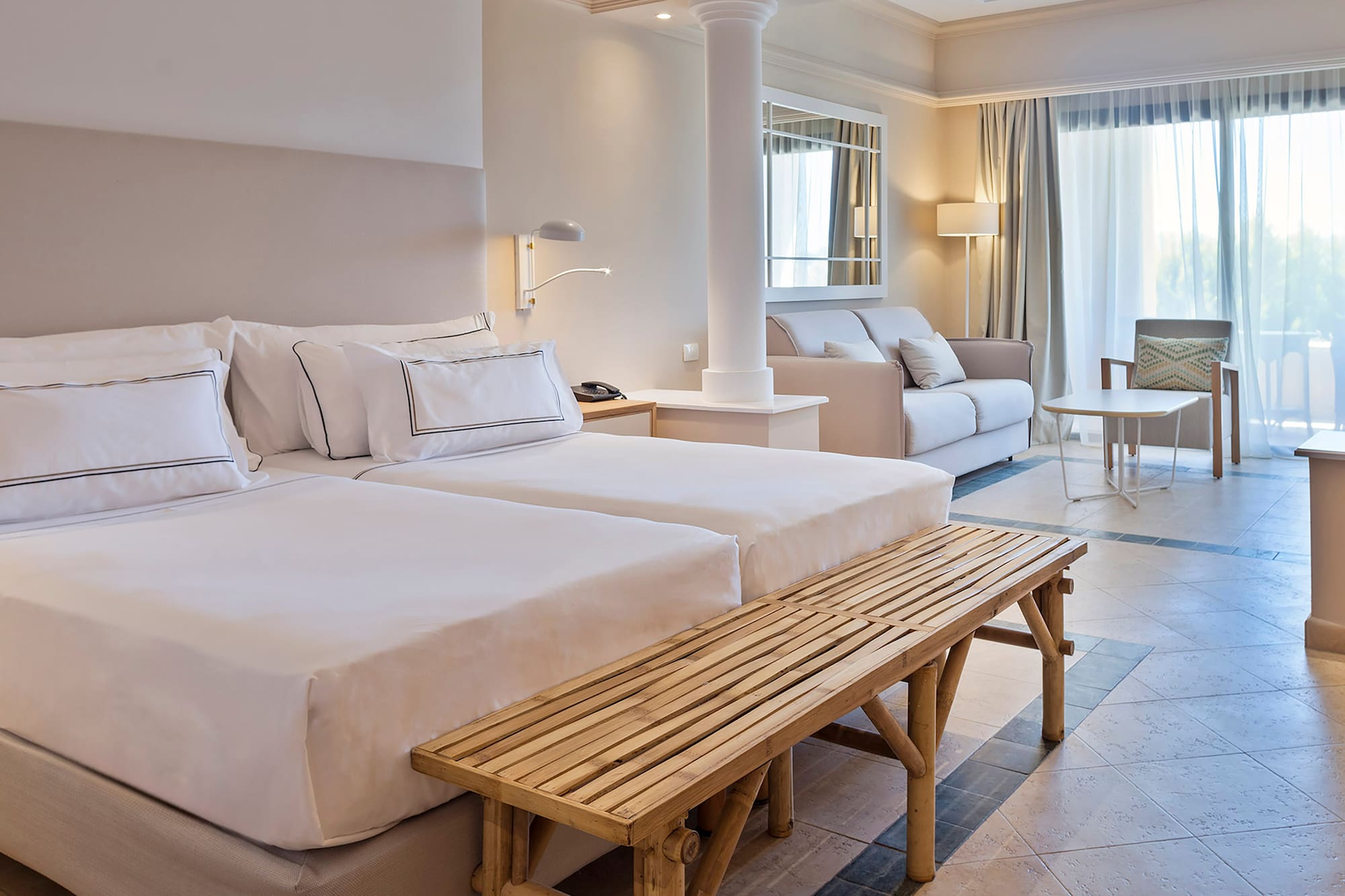 a room with two beds and a table