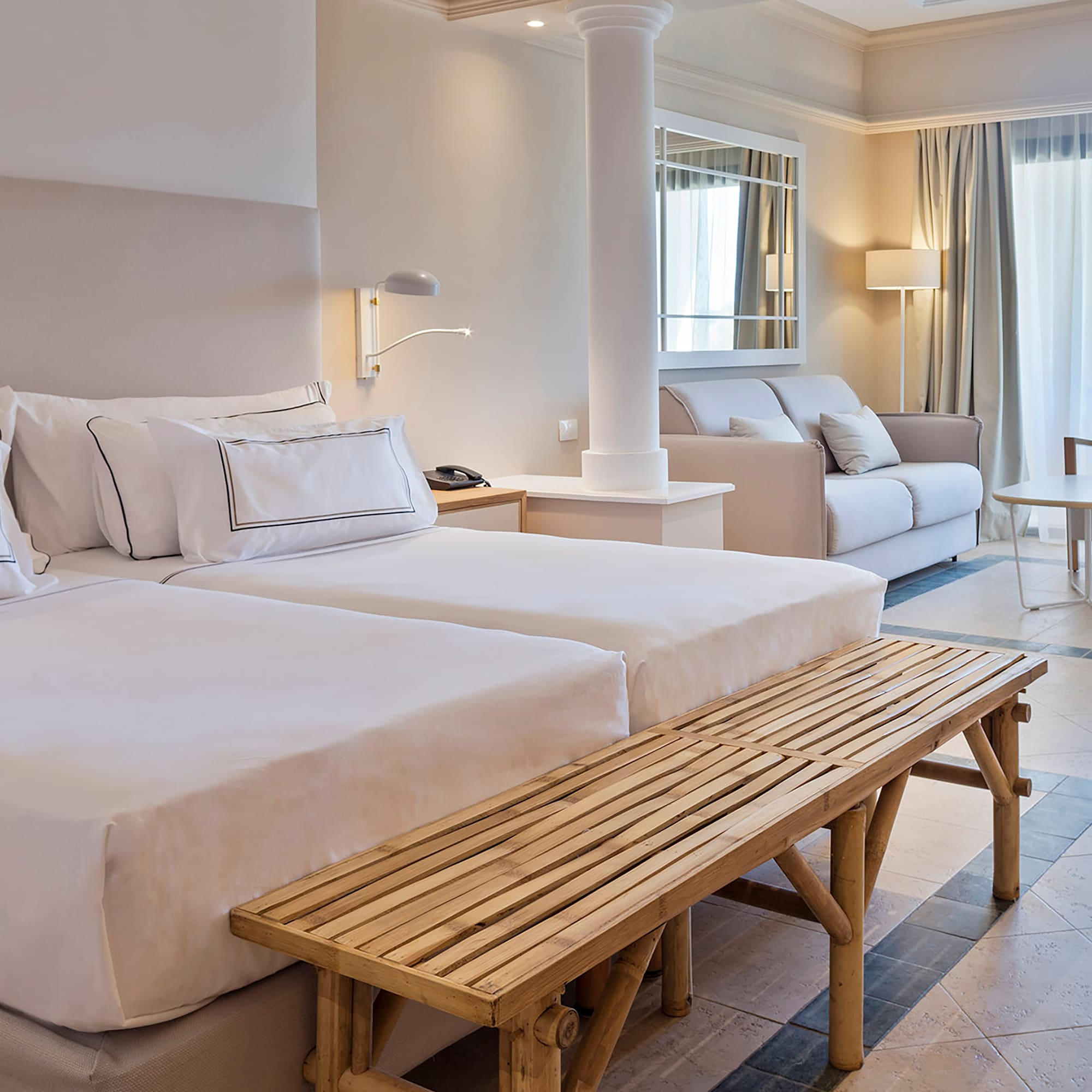 a room with two beds and a table