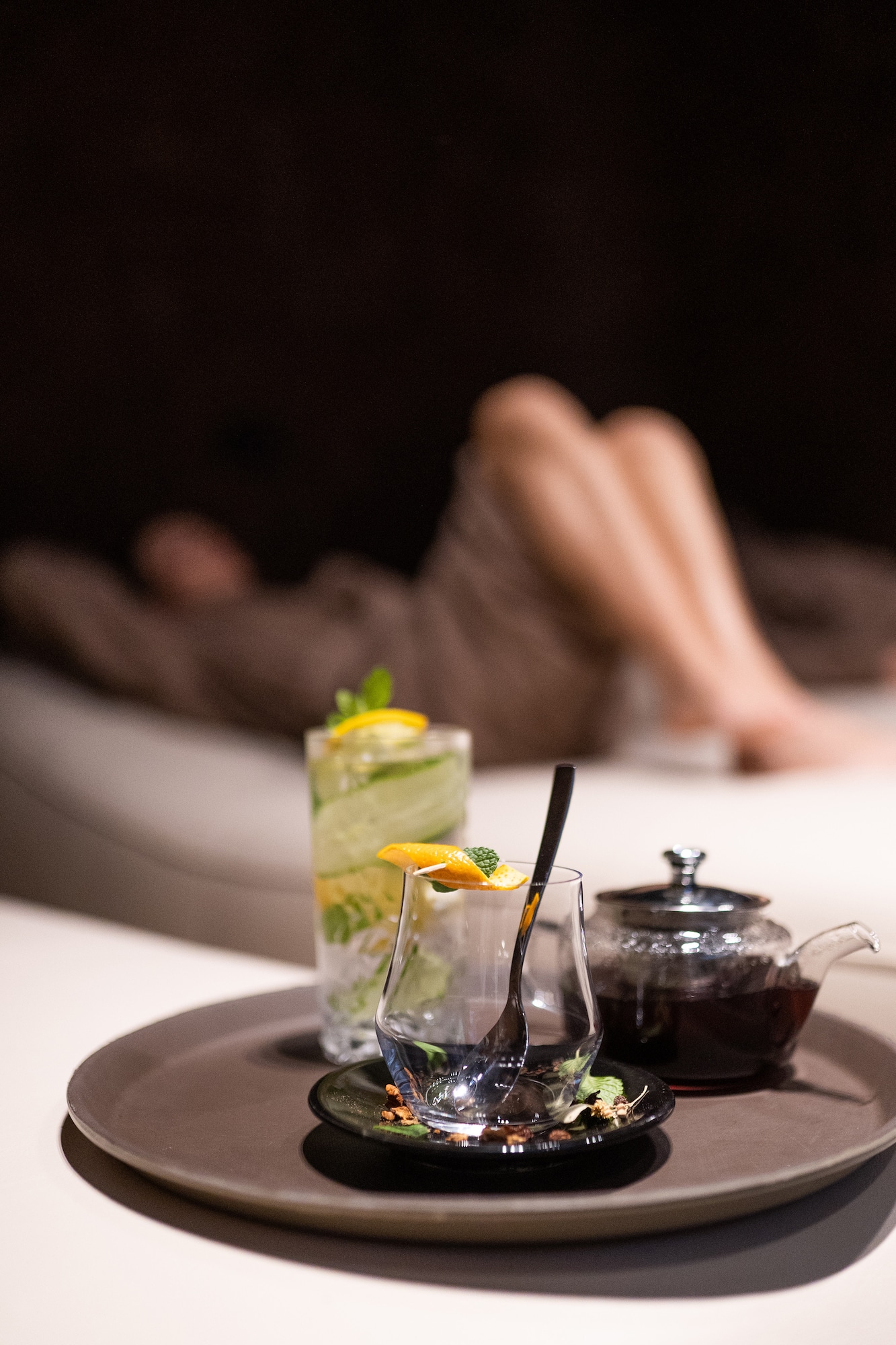 a glass and teapot on a plate