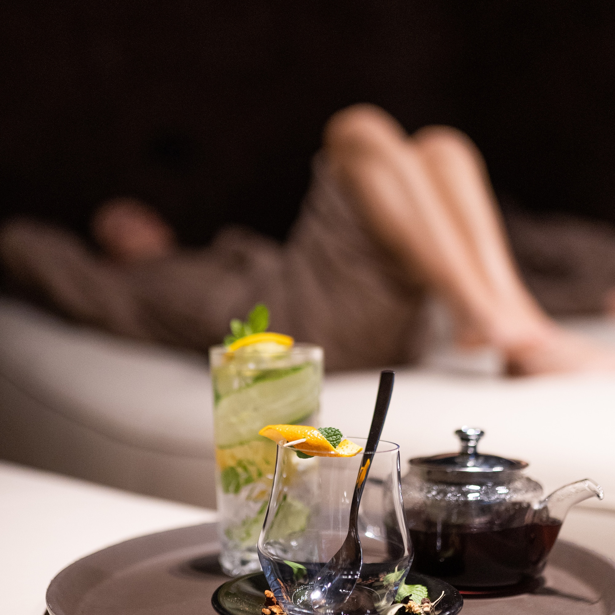 a glass and teapot on a plate