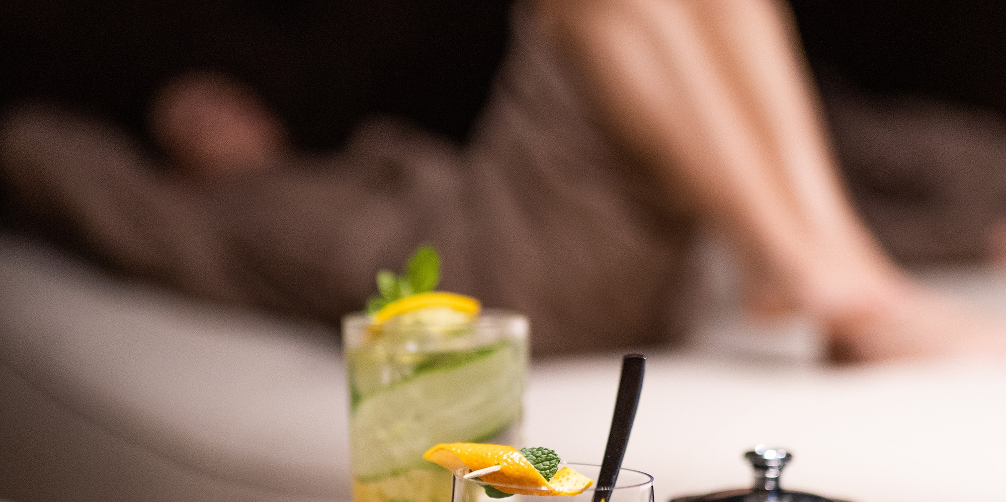 a glass and teapot on a plate