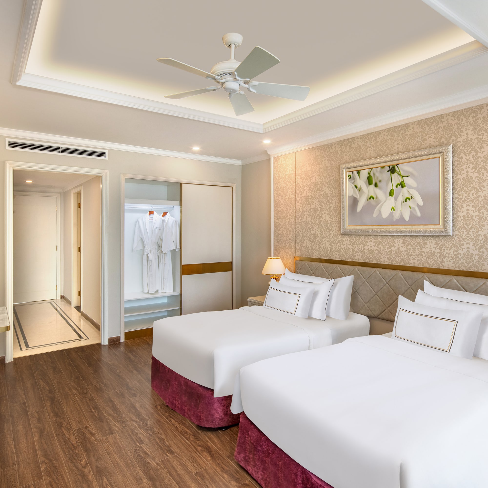 a room with two beds and a ceiling fan