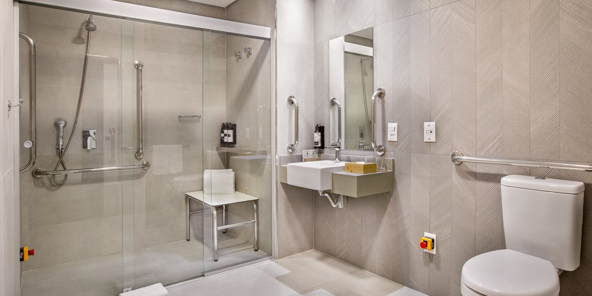 a bathroom with a glass shower and sink
