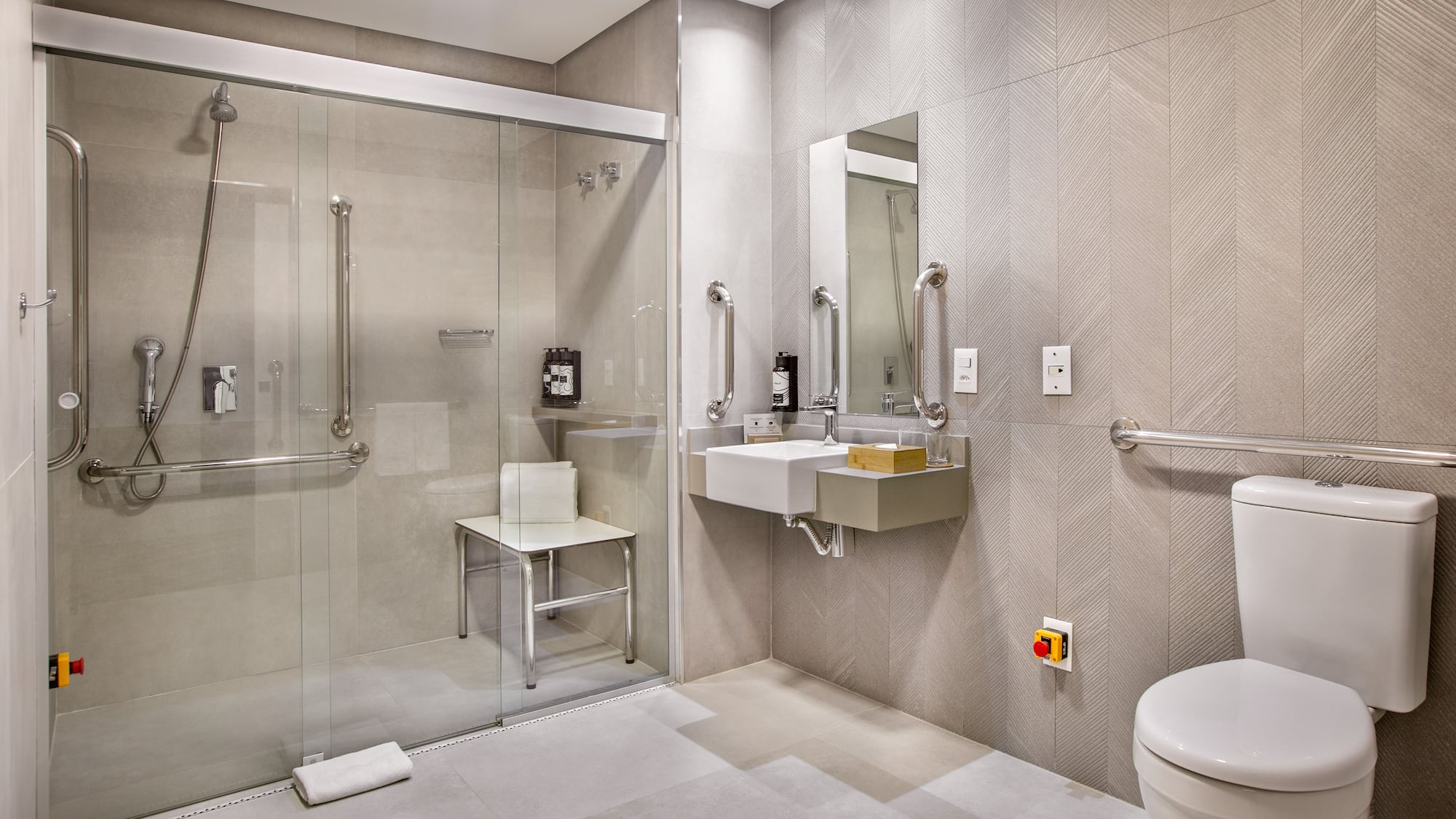 a bathroom with a glass shower and sink