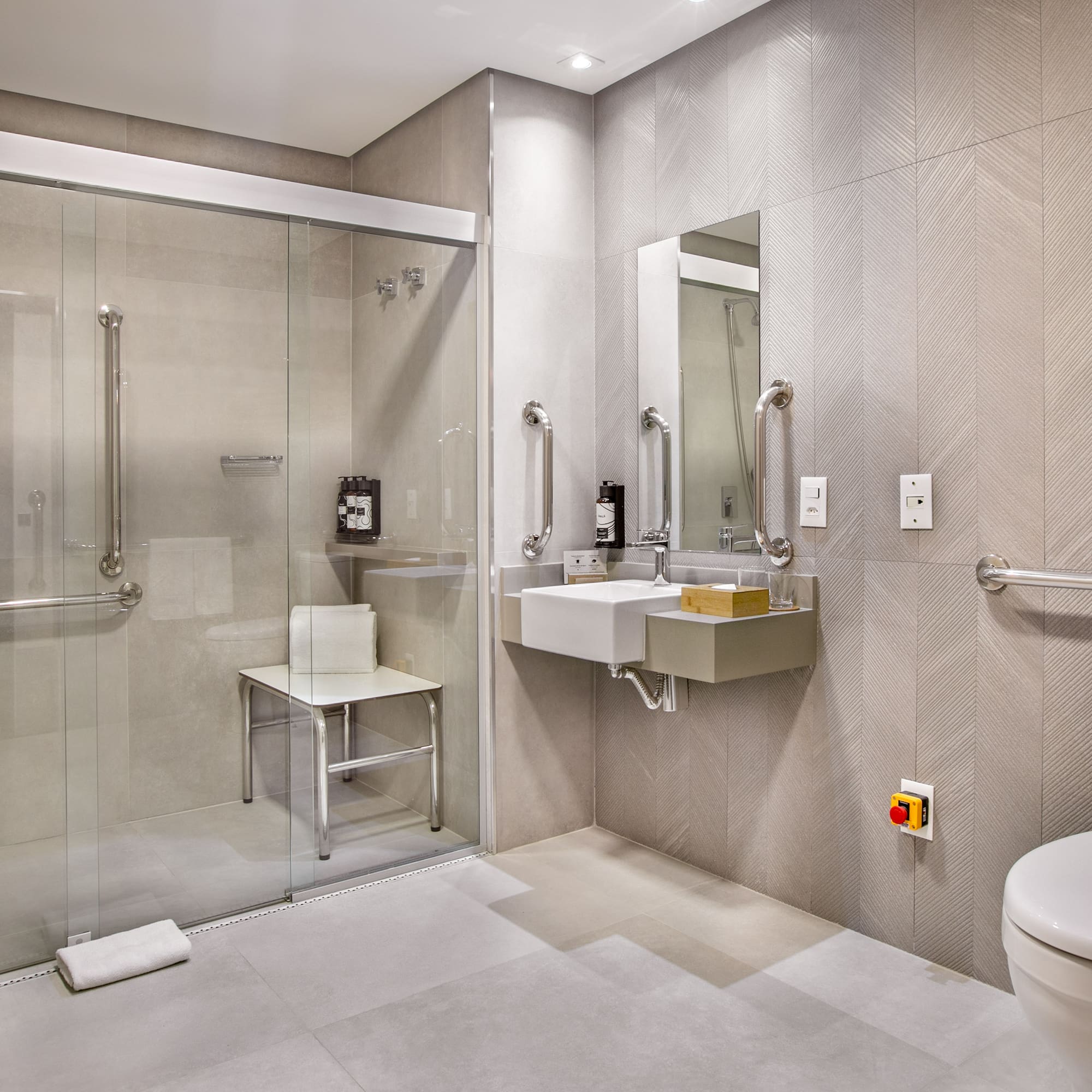 a bathroom with a glass shower and sink