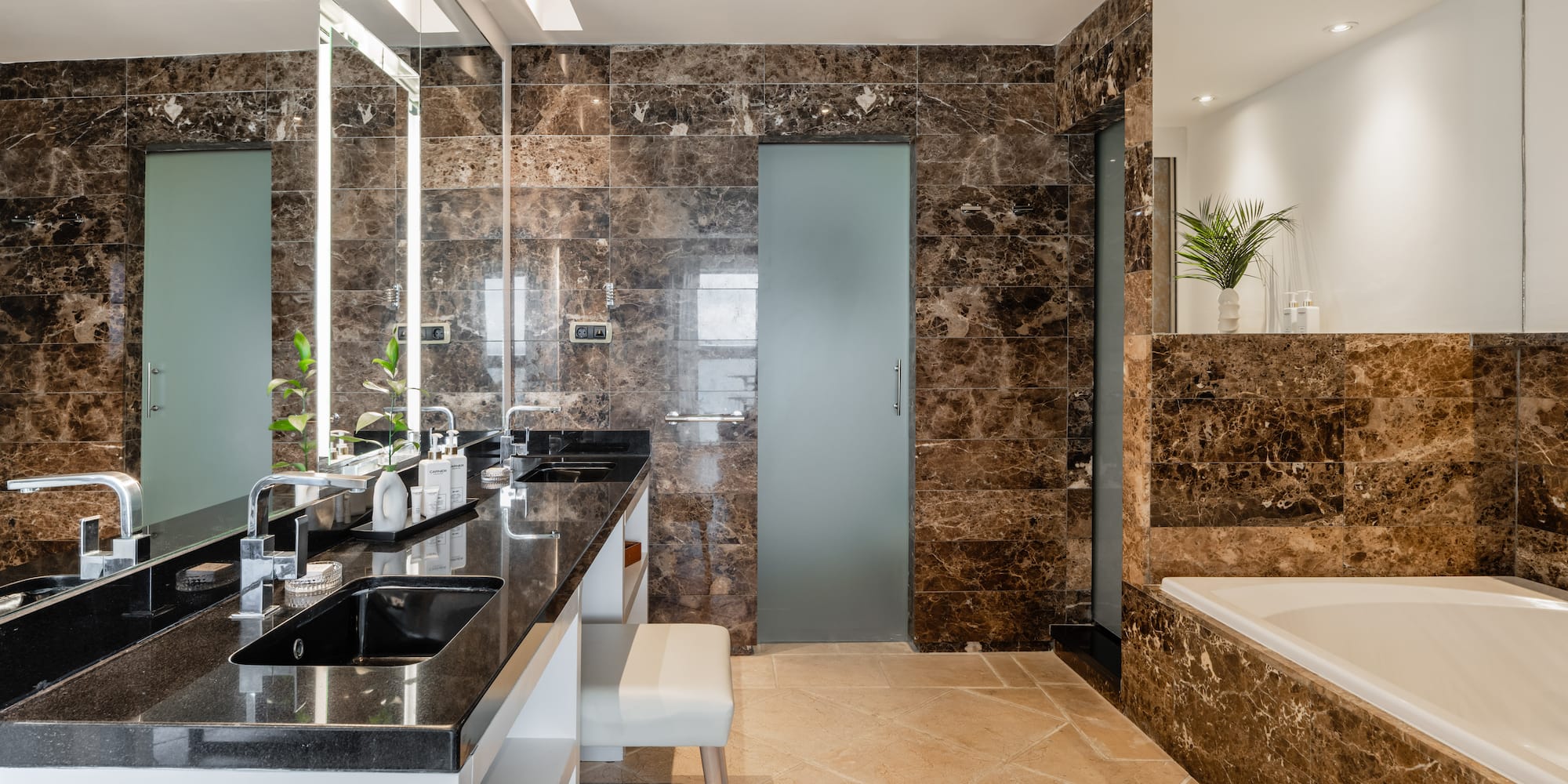 a bathroom with marble walls and a tub
