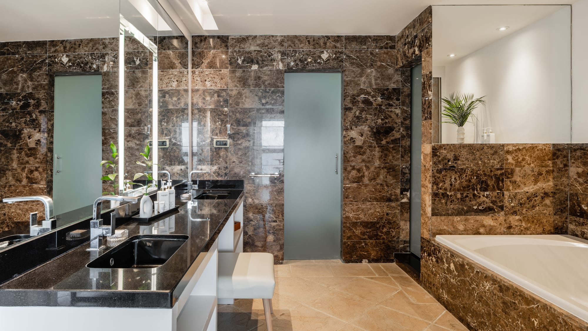 a bathroom with marble walls and a tub