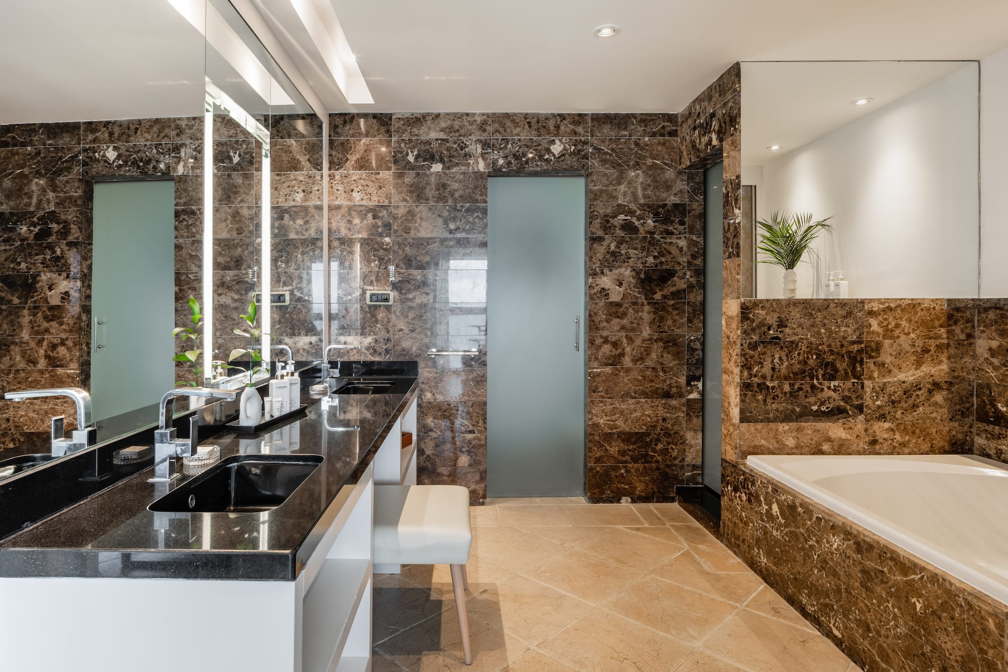 a bathroom with marble walls and a tub