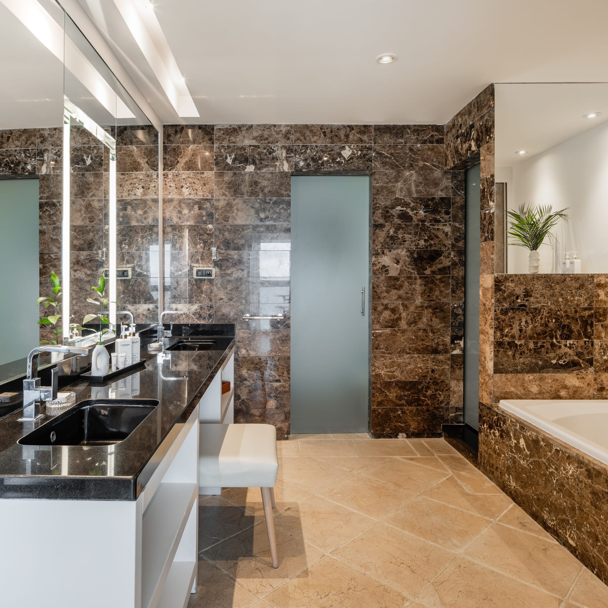 a bathroom with marble walls and a tub