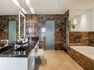 a bathroom with marble walls and a tub