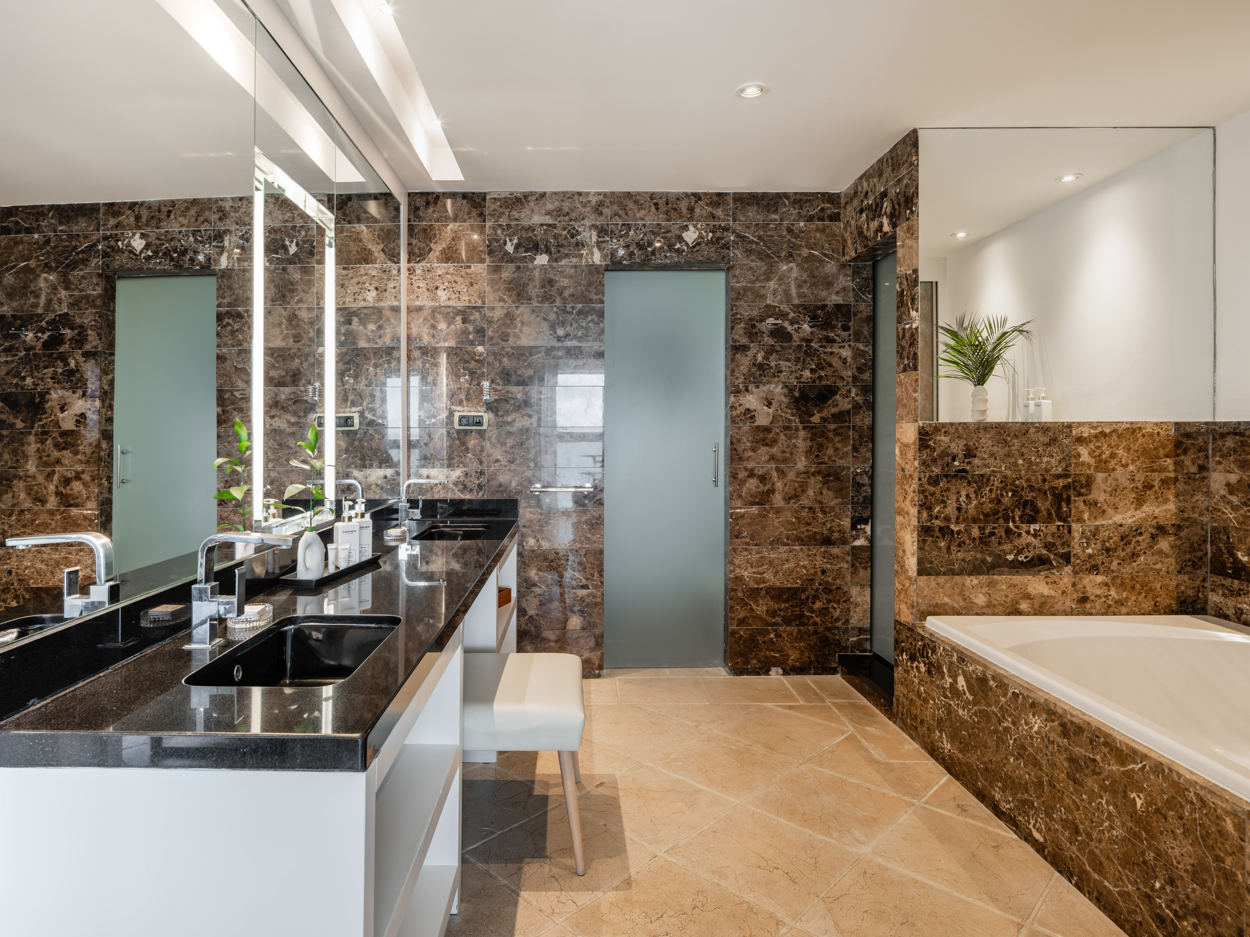a bathroom with marble walls and a tub