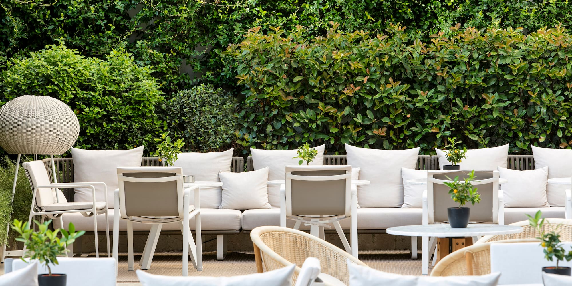a group of white chairs and tables outside