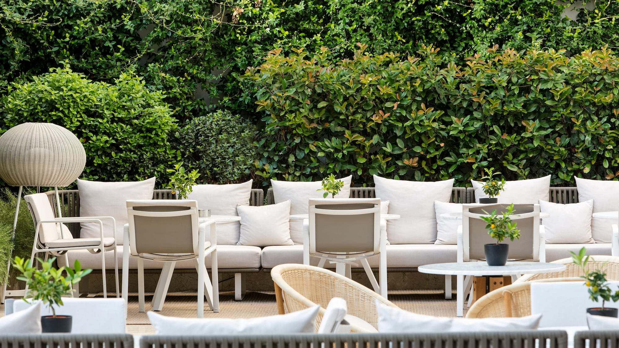a group of white chairs and tables outside