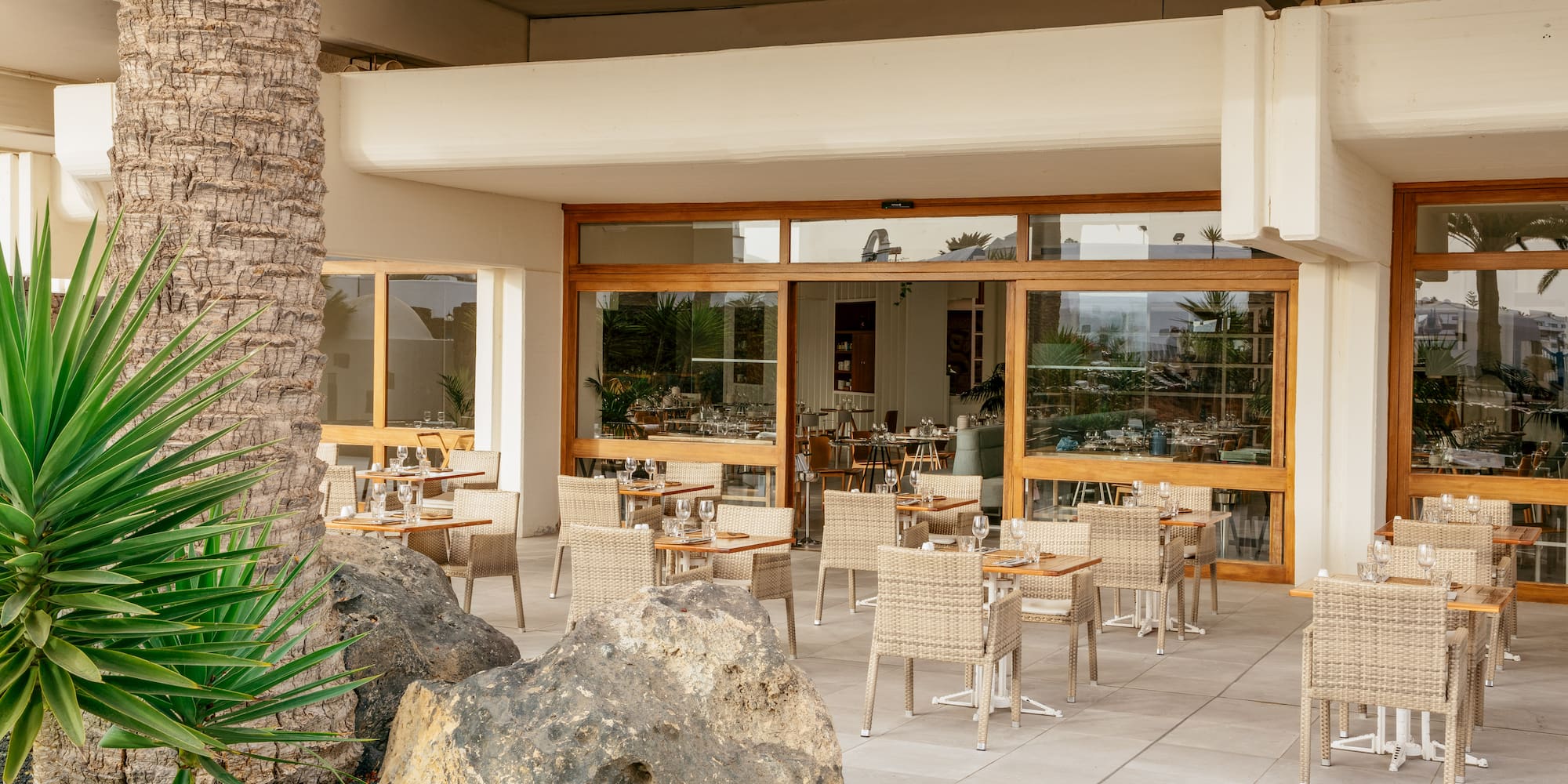 a patio with tables and chairs