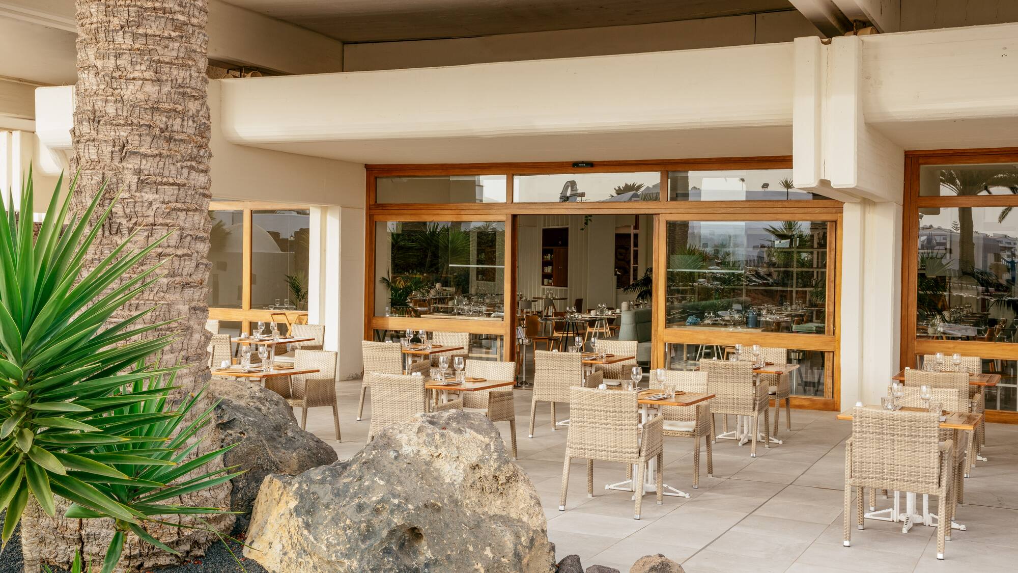 a patio with tables and chairs