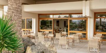 a patio with tables and chairs