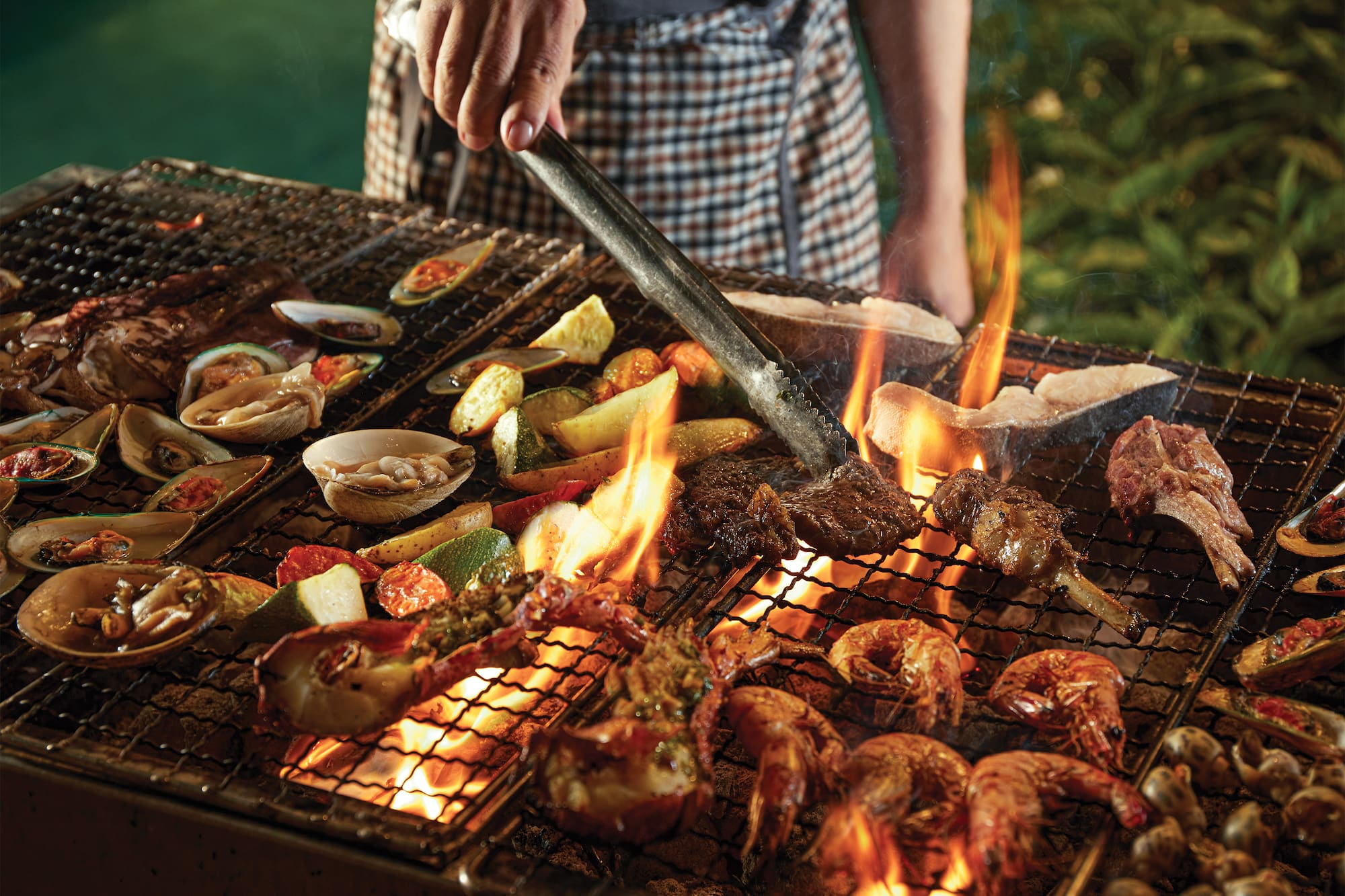 a person cooking food on a grill