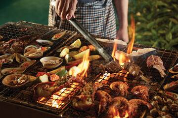 a person cooking food on a grill
