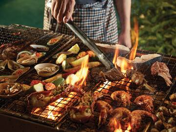 a person cooking food on a grill