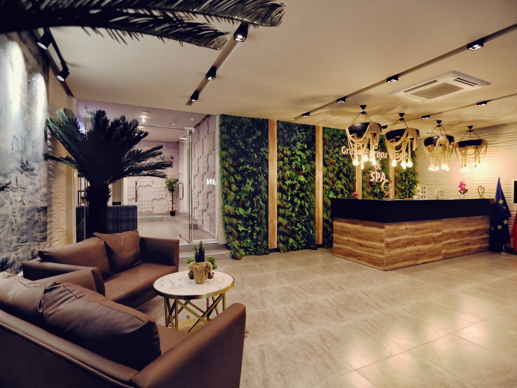 a lobby with a reception desk and plants