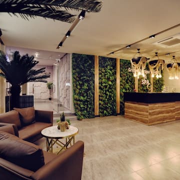 a lobby with a reception desk and plants