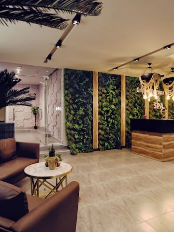 a lobby with a reception desk and plants