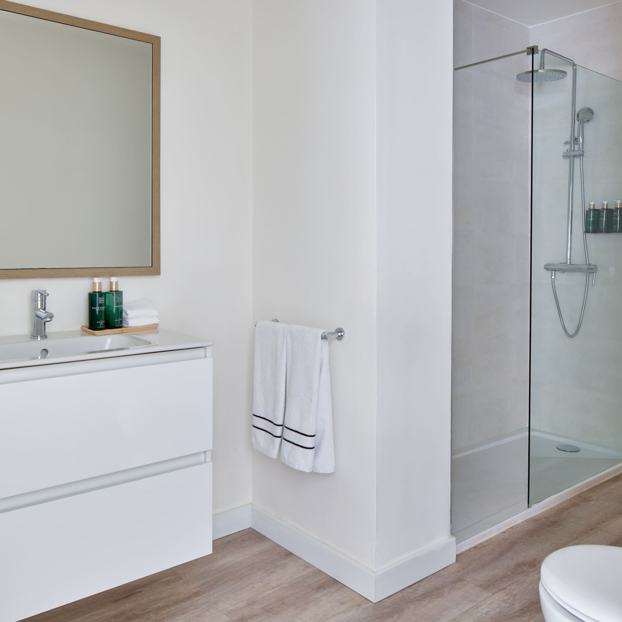 a bathroom with a glass shower and sink