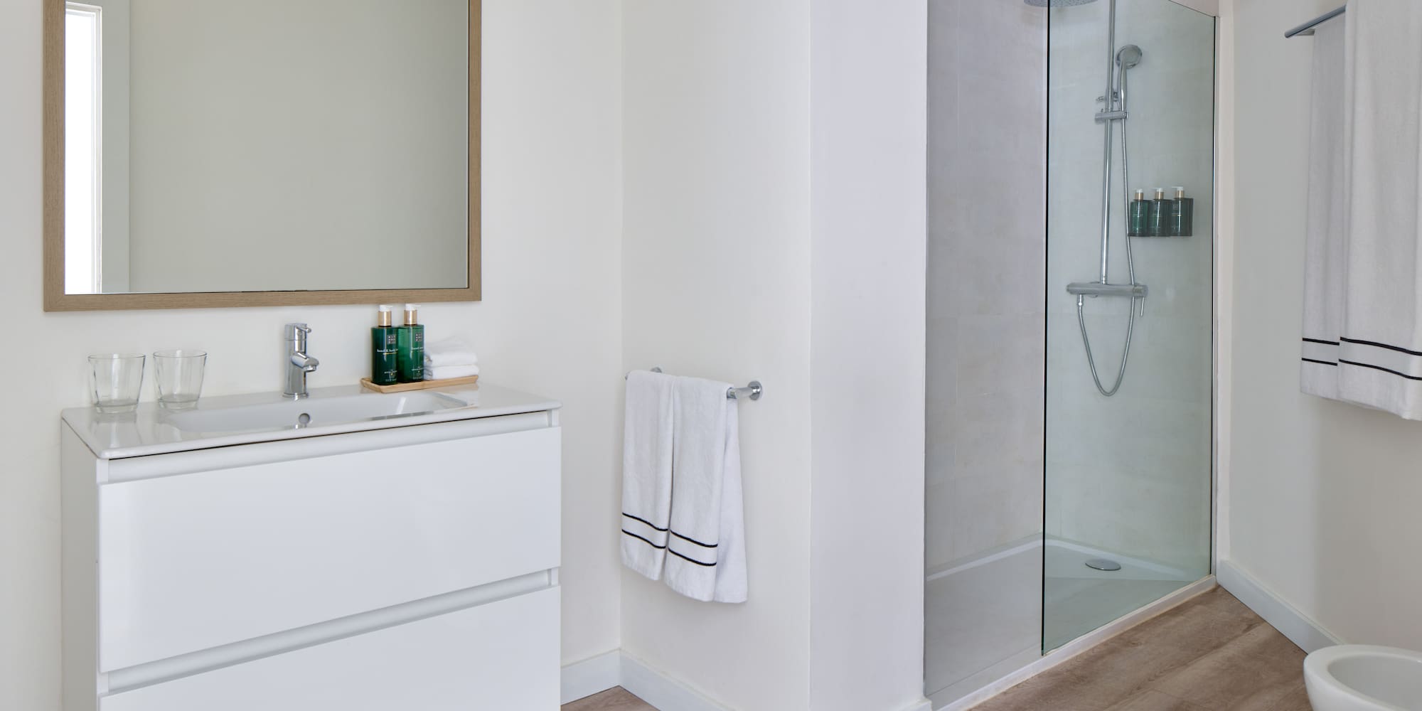 a bathroom with a glass shower and sink