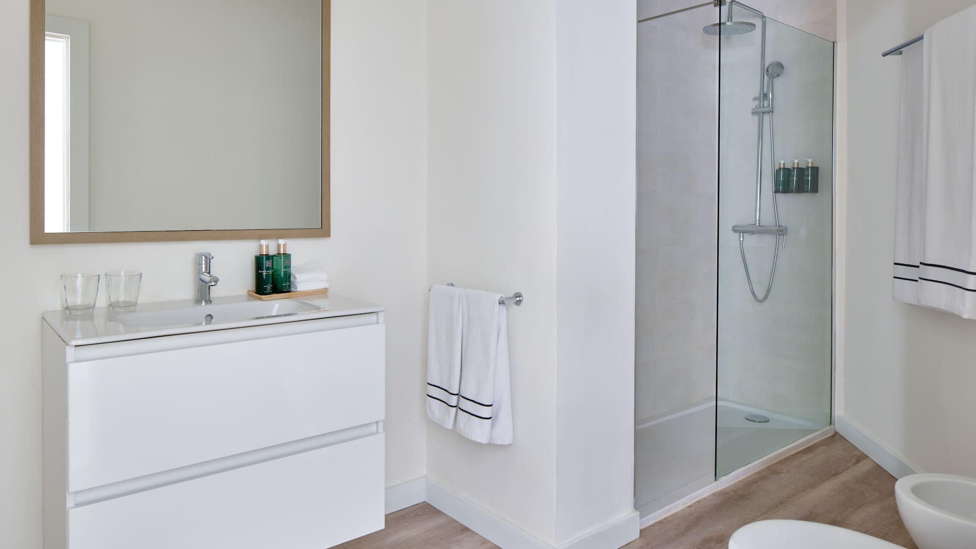 a bathroom with a glass shower and sink