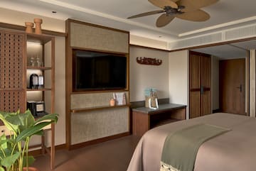 a room with a bed and a tv